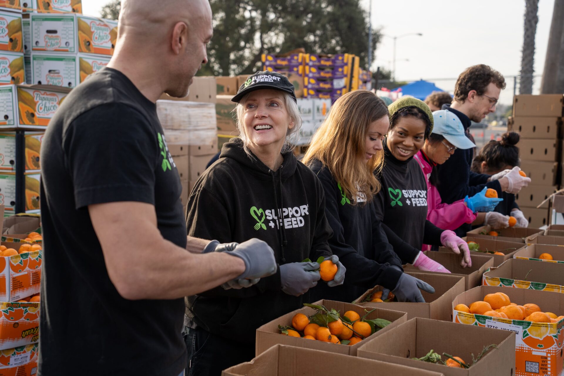 SUPPORT + FEED volunteers sorting produce